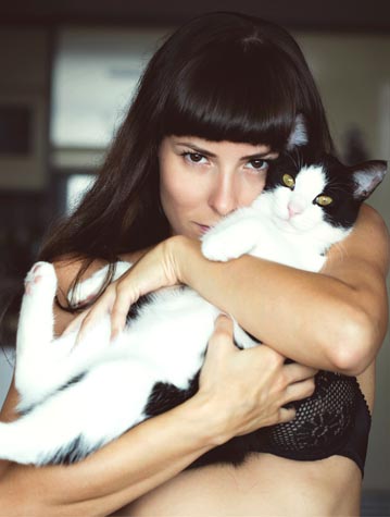 woman with cat in bra?